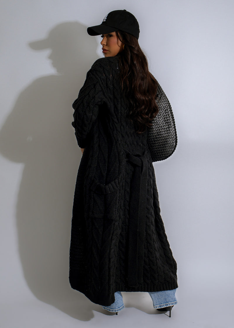  Close-up of the intricate knit pattern and luxurious black fabric of the Shadowfall Knit Duster Coat, perfect for layering in the cooler months