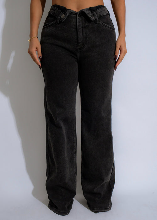 Vintage black high rise jeans with distressed details and frayed hem