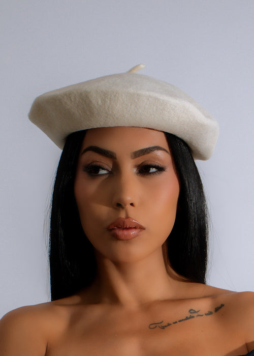 White beret with a stylish design, perfect for adding a touch of beauty to any urban outfit