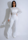 Close-up of white jumpsuit with rhinestones and celestial cage design