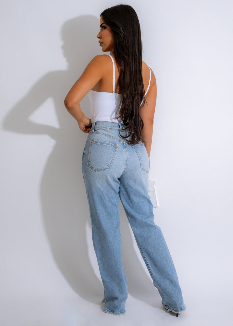 Model wearing the New Wave Ribbed Bodysuit White with high-waisted jeans