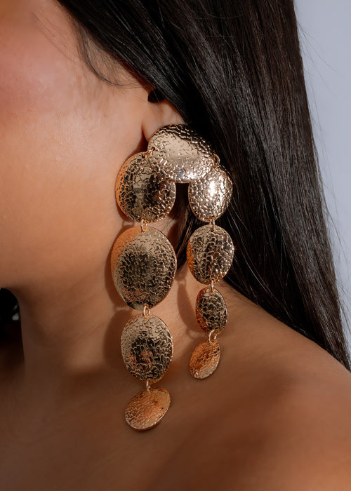 Shiny gold molten moon earrings with intricate details and elegant design