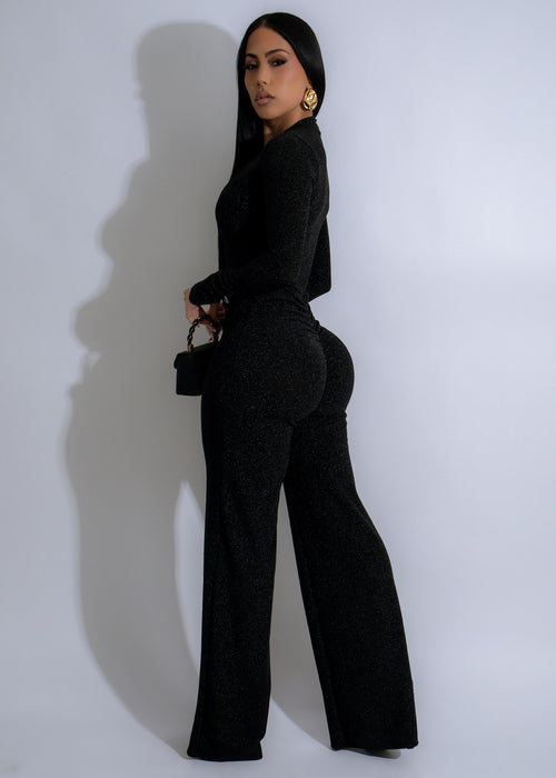  Glamorous full-body shot of the Obsidian Horizon Sparkle Ruched Jumpsuit in black, featuring a stunning sparkle effect and stylish ruched detailing