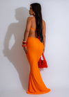 Two-piece bohemian outfit in vibrant orange with flowy skirt and matching top