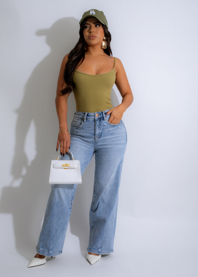  Woman wearing green ribbed bodysuit with high-waisted denim jeans 