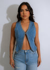 Close-up of blue denim vest top with sparkling rhinestones and intricate stitching design