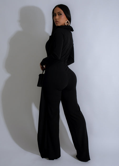  Side view of Vanguard Grace Jumpsuit Black, showcasing the elegant and flattering silhouette with a cinched waist and flowy pants