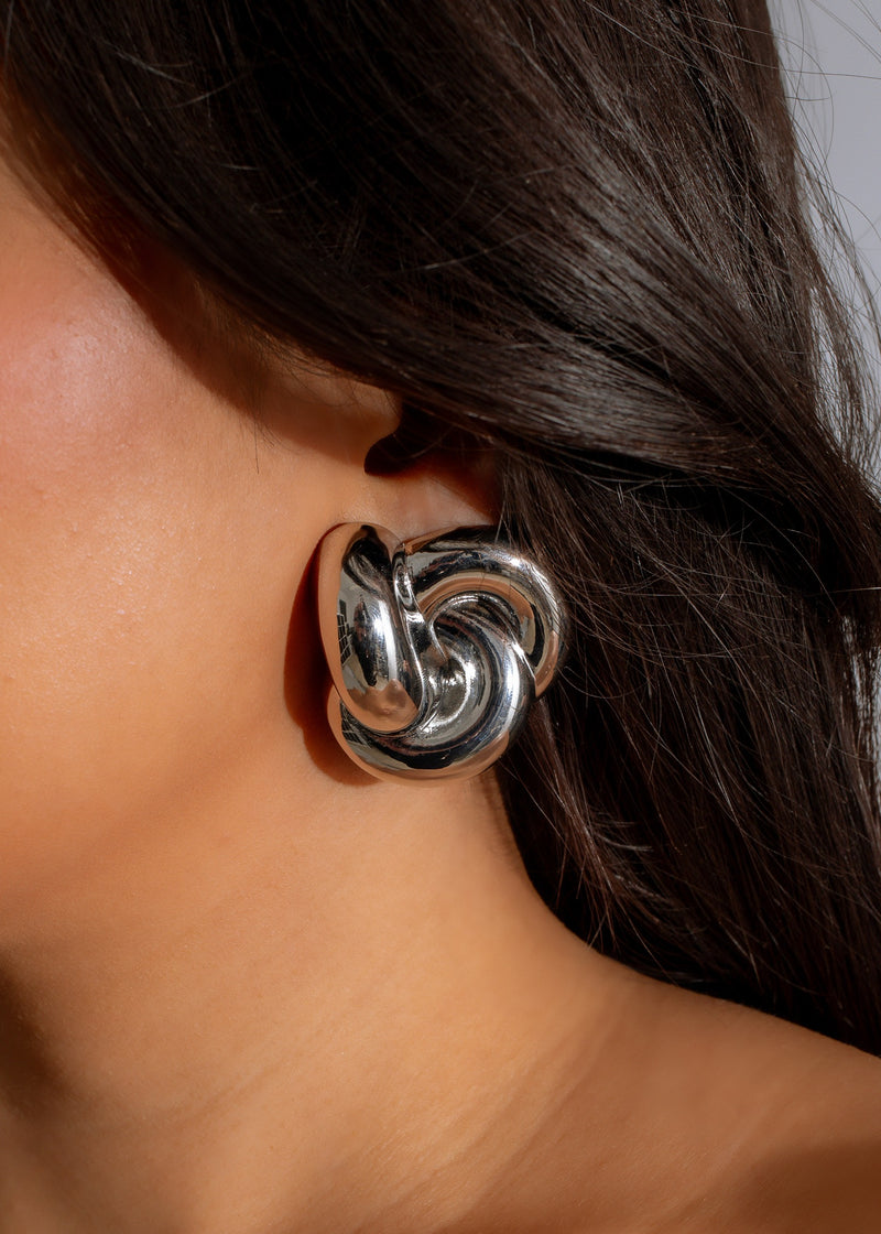 Silver earring with a unique design representing individuality and style