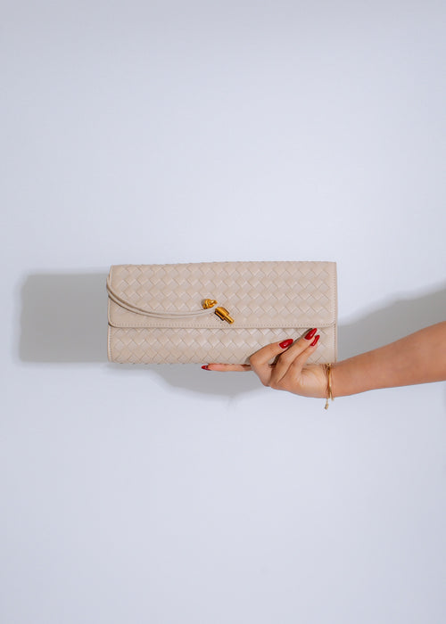 The Woven Grace Clutch White, a stylish and elegant accessory for any occasion, featuring intricate weaving and a sleek white design, perfect for adding a touch of sophistication to your ensemble 