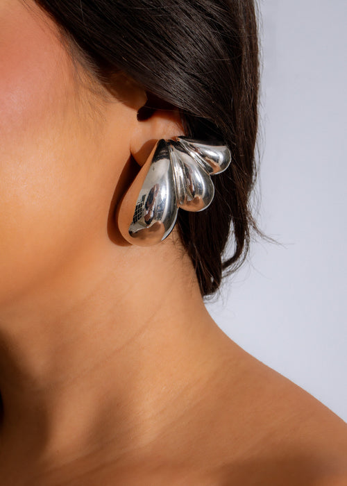 Beautiful silver statement earrings with intricate design and shimmering details