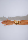  Elegant and stylish gold cuff bracelet with a wave pattern and sleek, polished look