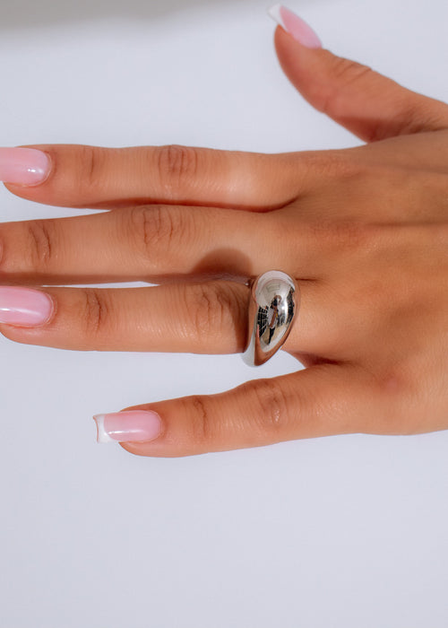 Shiny silver ring with intricate details and timeless elegance on display 