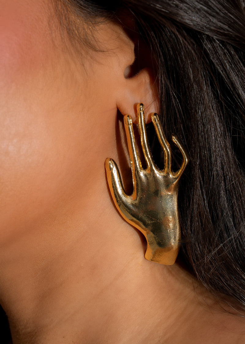 Shiny gold earrings with intricate and creative hand design for women