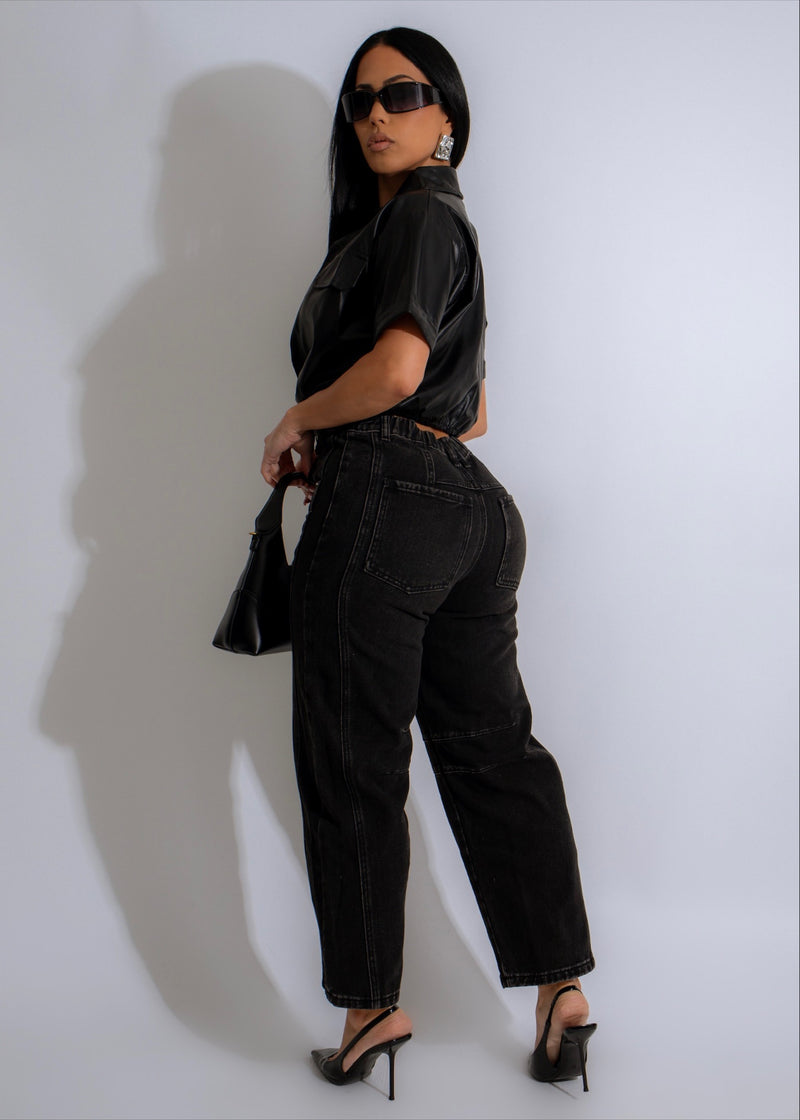 A woman wearing the Canyon Breeze Faux Leather Crop Top Black, paired with a leather jacket and statement jewelry