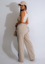 High-waisted light nude denim pants with a relaxed fit and distressed detailing