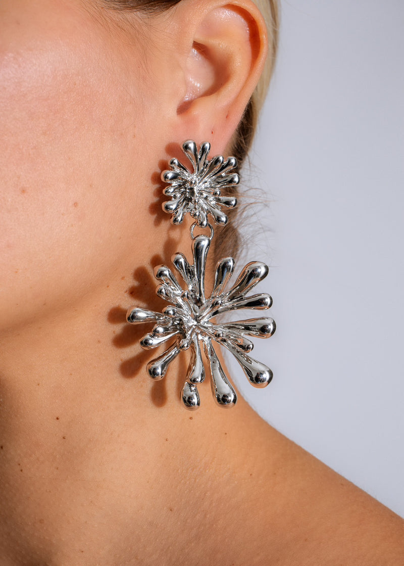 Shiny silver solar flare earring with intricate design and elegant style