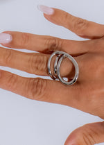 Shiny silver modern twist ring with intricate design and sleek finish