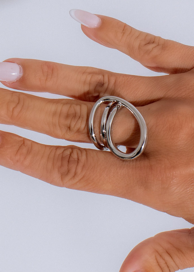 Shiny silver modern twist ring with intricate design and sleek finish