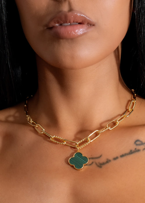 Handcrafted clover charm necklace with vibrant green enamel detailing and delicate gold chain