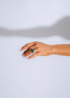  Elegant hand wearing the 'Made You Look Ring Green' against a natural backdrop, showcasing its stunning color and design