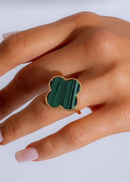 Close-up shot of the vibrant green 'Made You Look Ring' with intricate details and a shimmering finish