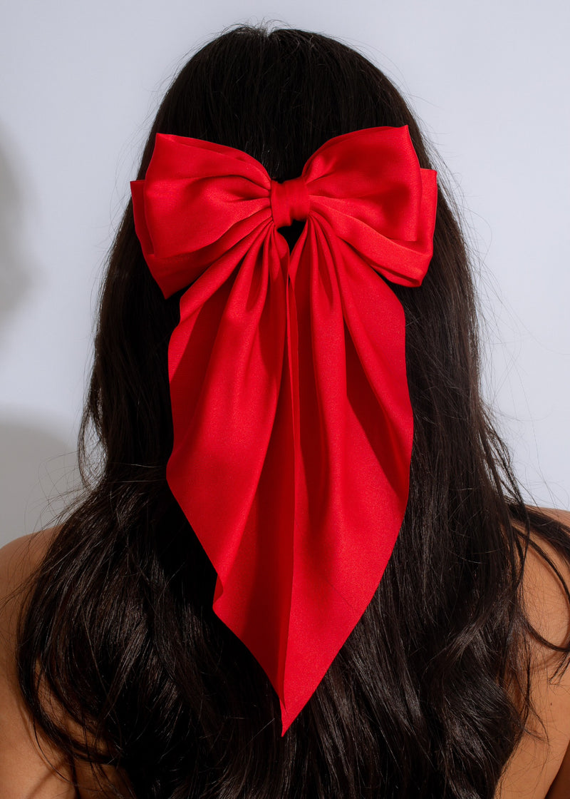 Red velvet bow with shimmering accents, a perfect accessory for any occasion