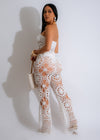 Close-up of white crochet pants with matching crochet top outfit