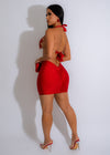 A woman sitting and posing in the trendy red Signature Diva Mini Skirt