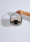 The Belle Saddle Handbag Black, a sleek and stylish crossbody bag with adjustable strap and gold-tone hardware, perfect for everyday use and evening outings