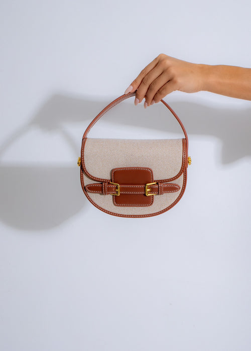 The Belle Saddle Handbag Brown, a stylish leather bag with adjustable straps and multiple compartments for everyday use