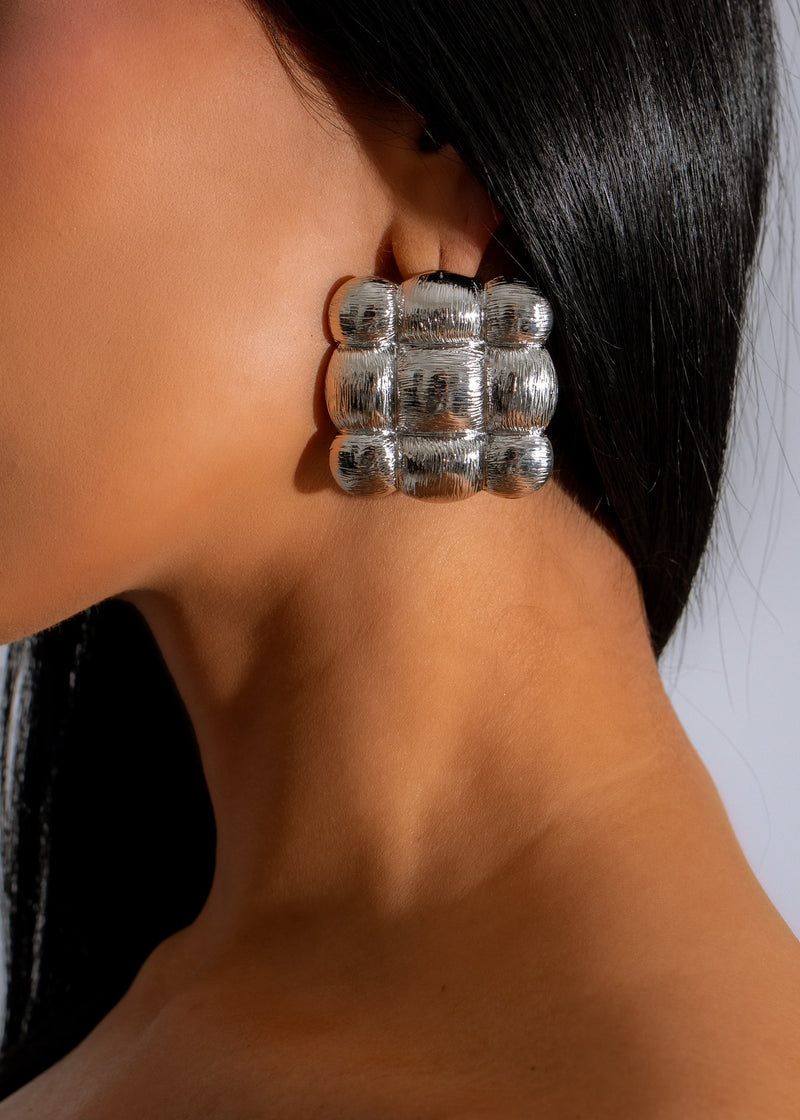 Silver earring with intricate design, perfect for adding a unique touch to any outfit