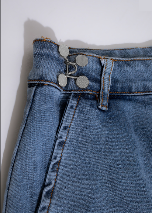 Silver Instant Fit Button shown on a pair of jeans, providing a convenient and stylish solution for pants that are too tight